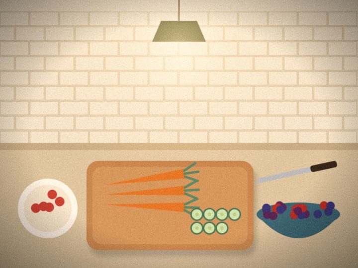 Illustration of a kitchen counter with a cutting board of carrots and cucumber, a bowl of berries and a pendant light.