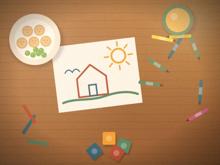 Illustration of a kitchen table with a child's crayon drawing of a house, crayons, building blocks and a snack plate.